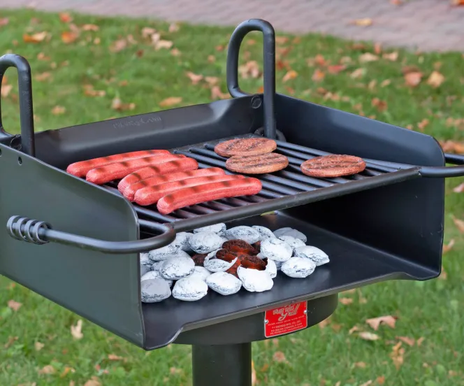 charcoal grill with burgers and hotdogs grilling