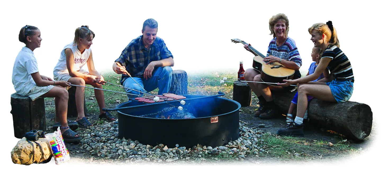 a family sitting around a campfire ring