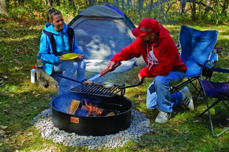 people cooking at a campsite