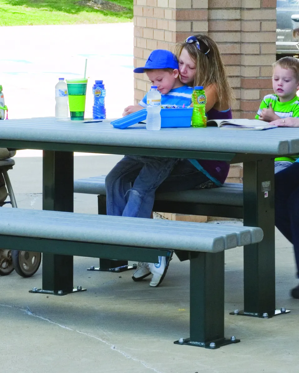 family sitting at an outdoor picnic table