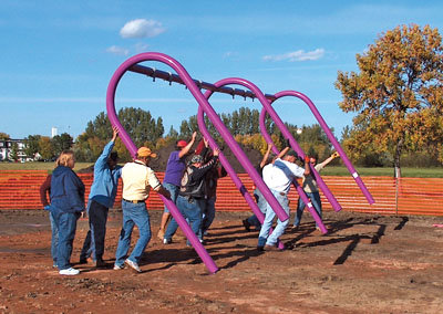 People erecting a swing set